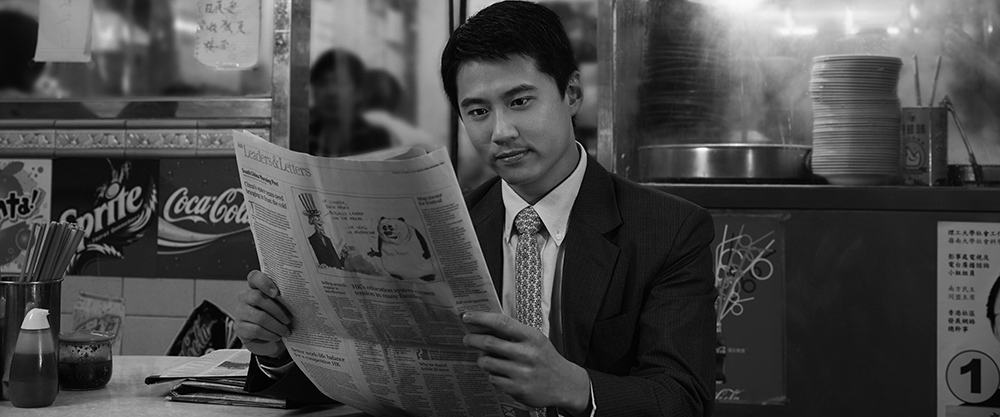 A person reading latest investment news; image used for ‘Give Clarity’ page.
