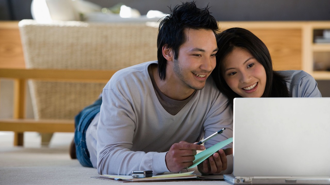 young couple with a computer, the image used for wealth
