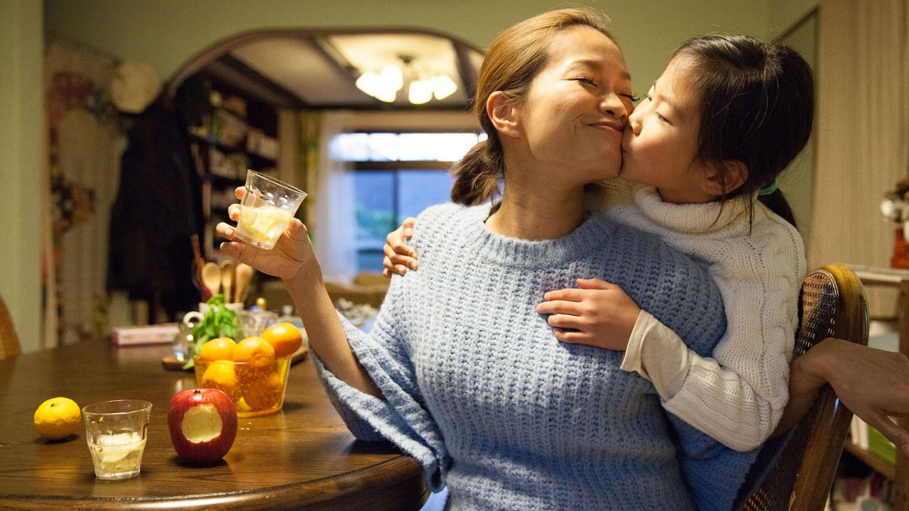 daughter is kissing mother; the image used for wealth family