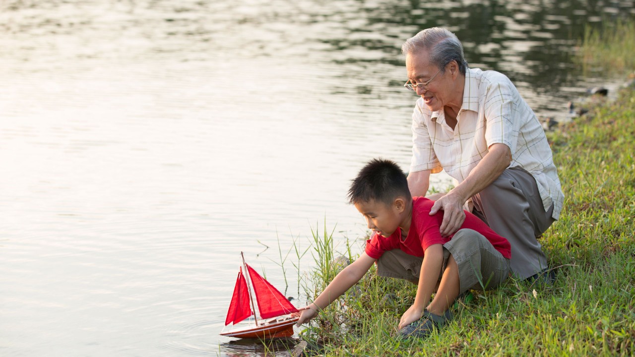 grandfather and grandson by the river , image is used for plan your retirement