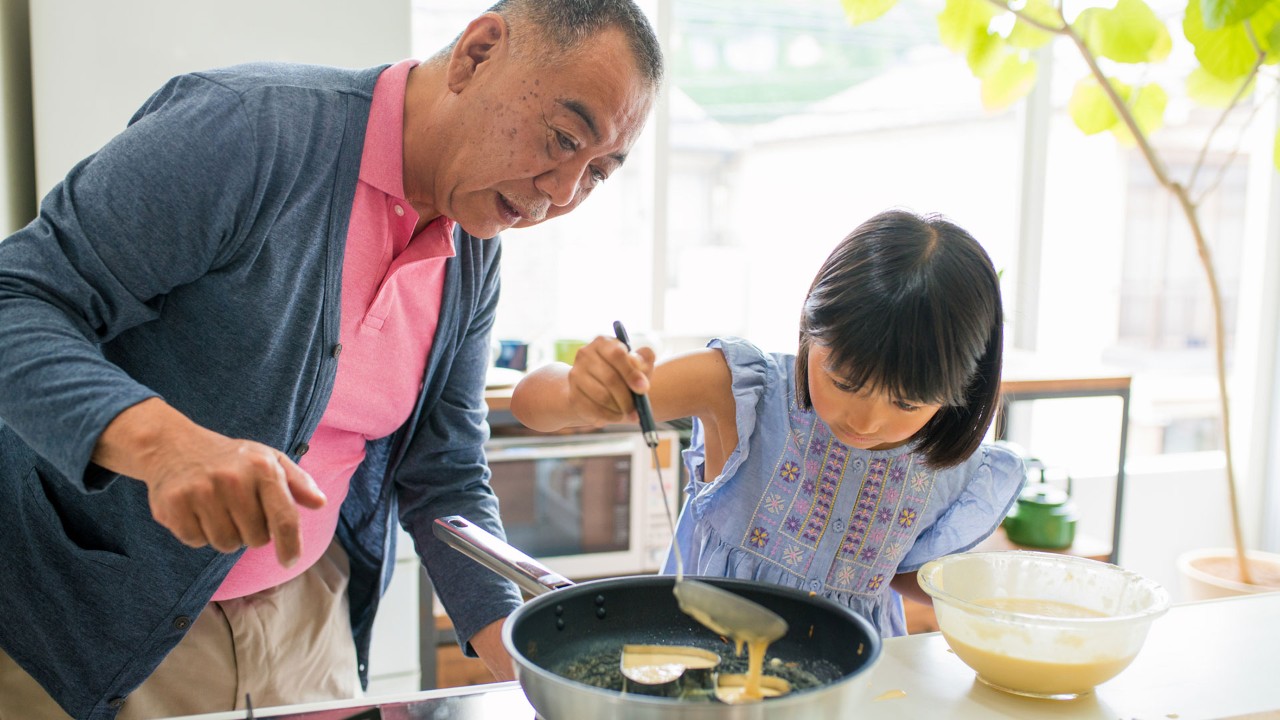 grandpa and granddaughter make omelet; the image used for 5 reasons you should start planning for retirement early
