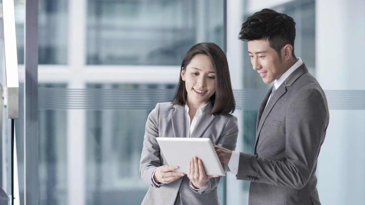 Colleagues watching tablet together; used for HSBC China Employee Banking Solution page