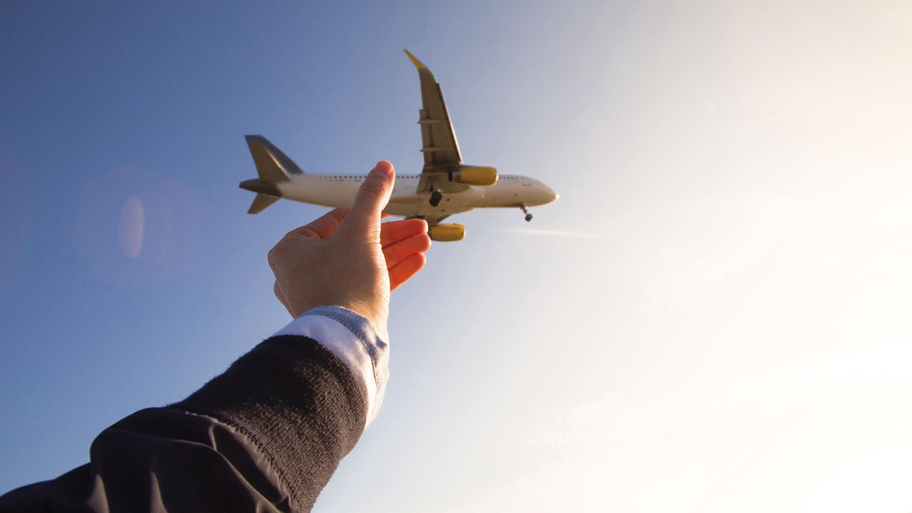 Man holding an airplane model; used for HSBC China Employee Banking Solution page