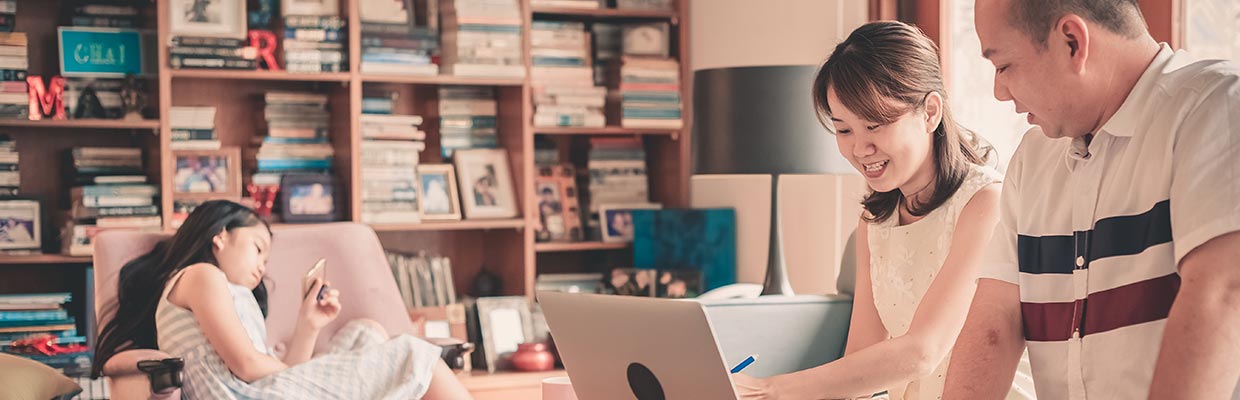 couple looking at computer; the image used for long-term financial management plan for your family