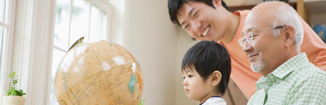 Three generations of grandparents watching the globe;the image used for wealth legacy page