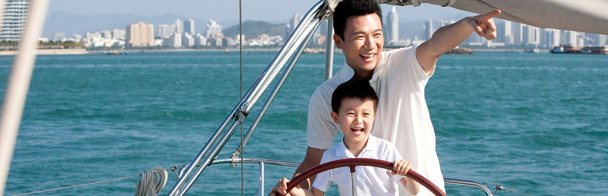 father and son on the yacht; used for AXATP “SmartCare Elite” Individual Health Insurance