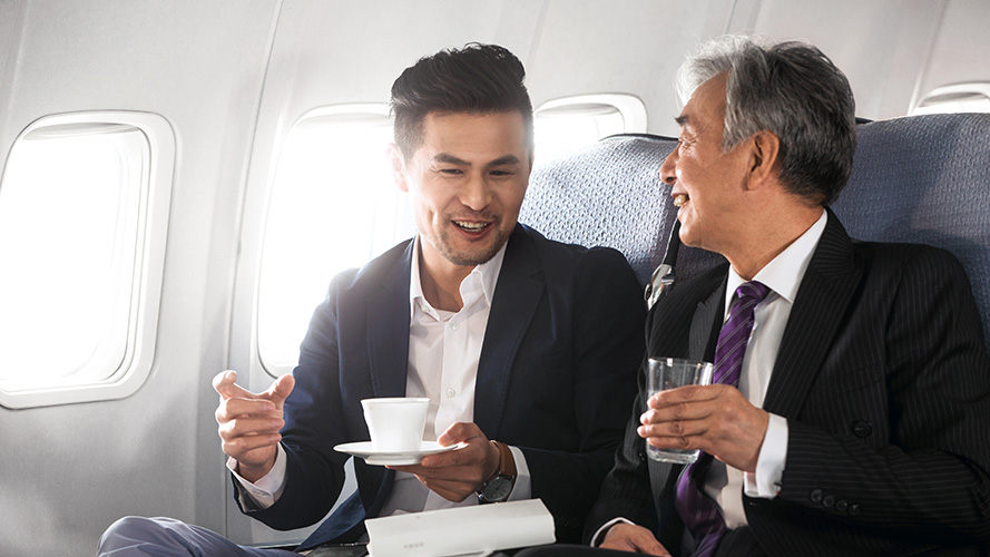 Businessmen talking on the plane; used for HSBC China Employee Banking Solution page