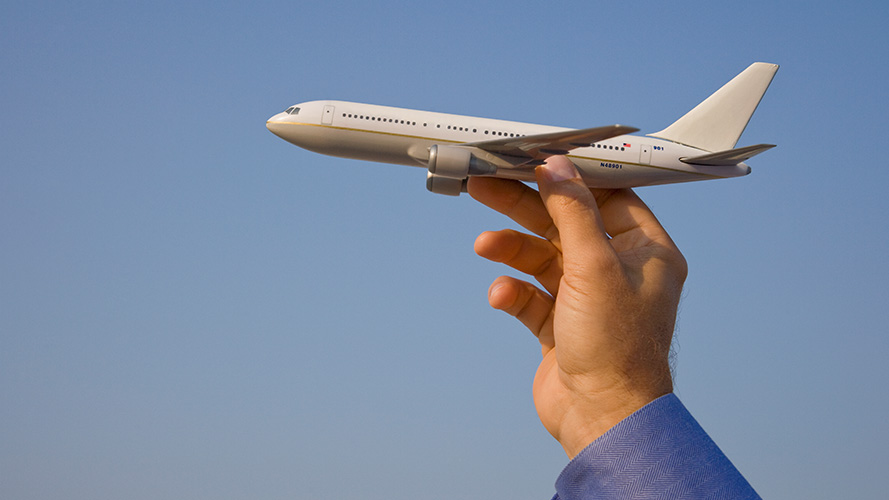 Man holding an airplane model; used for HSBC China Employee Banking Solution page