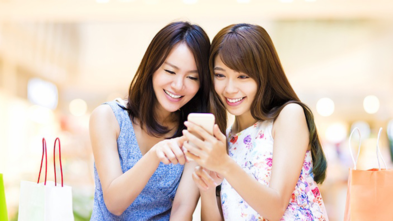 Two girls looking at mobile phone,image used for Explore credit card offers