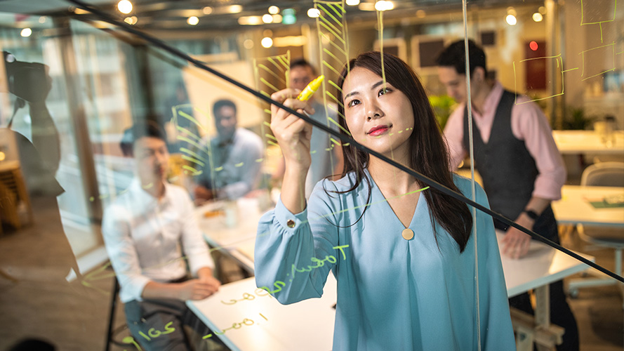 A person using mobile phone in office; image used for Knowledge Centre page.