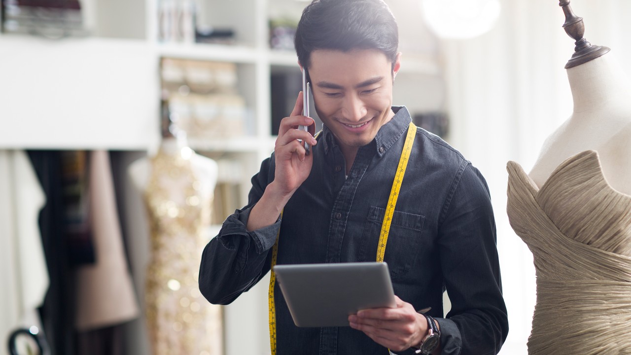 A man using his tablet device; image used for HSBC Fusion cross border payment campaign page.