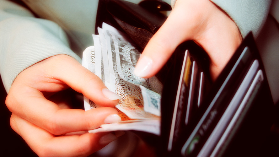 Woman viewing foreign currency in wallet