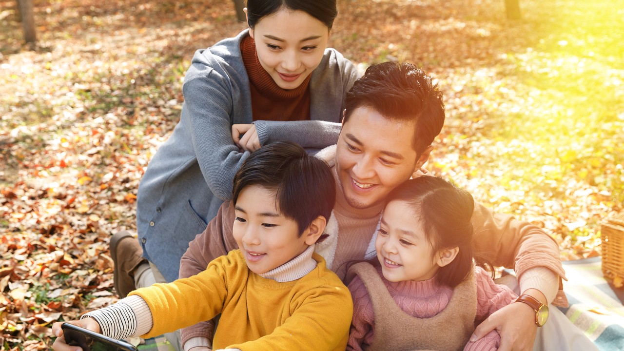 A happy family of three; the image used for protect what matters 