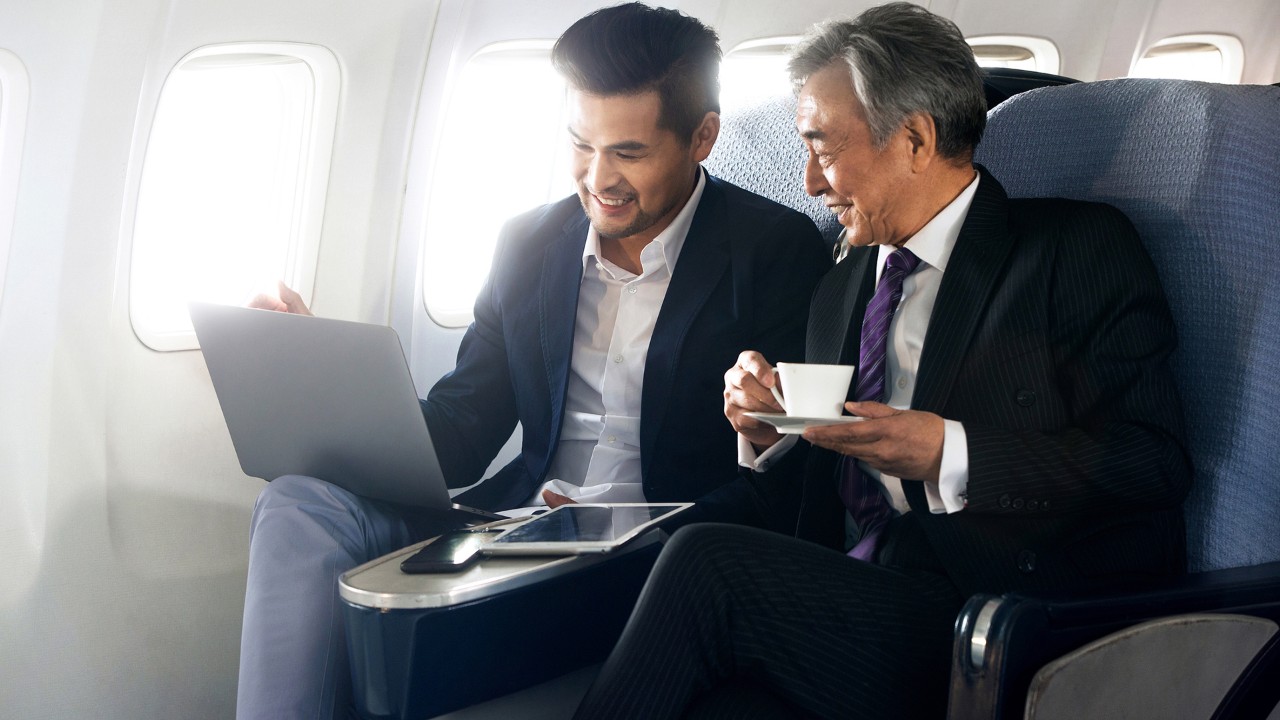 Businessmen talking on the plane; used for HSBC China Employee Banking Solution page