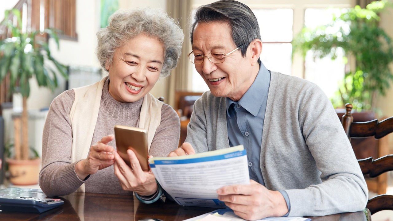 elder couple are searching information; the image used for long-term financial management plan for your family
