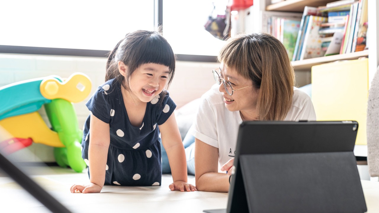 Mother and daughter looking at the tablet; the image used for getting into a savings habit