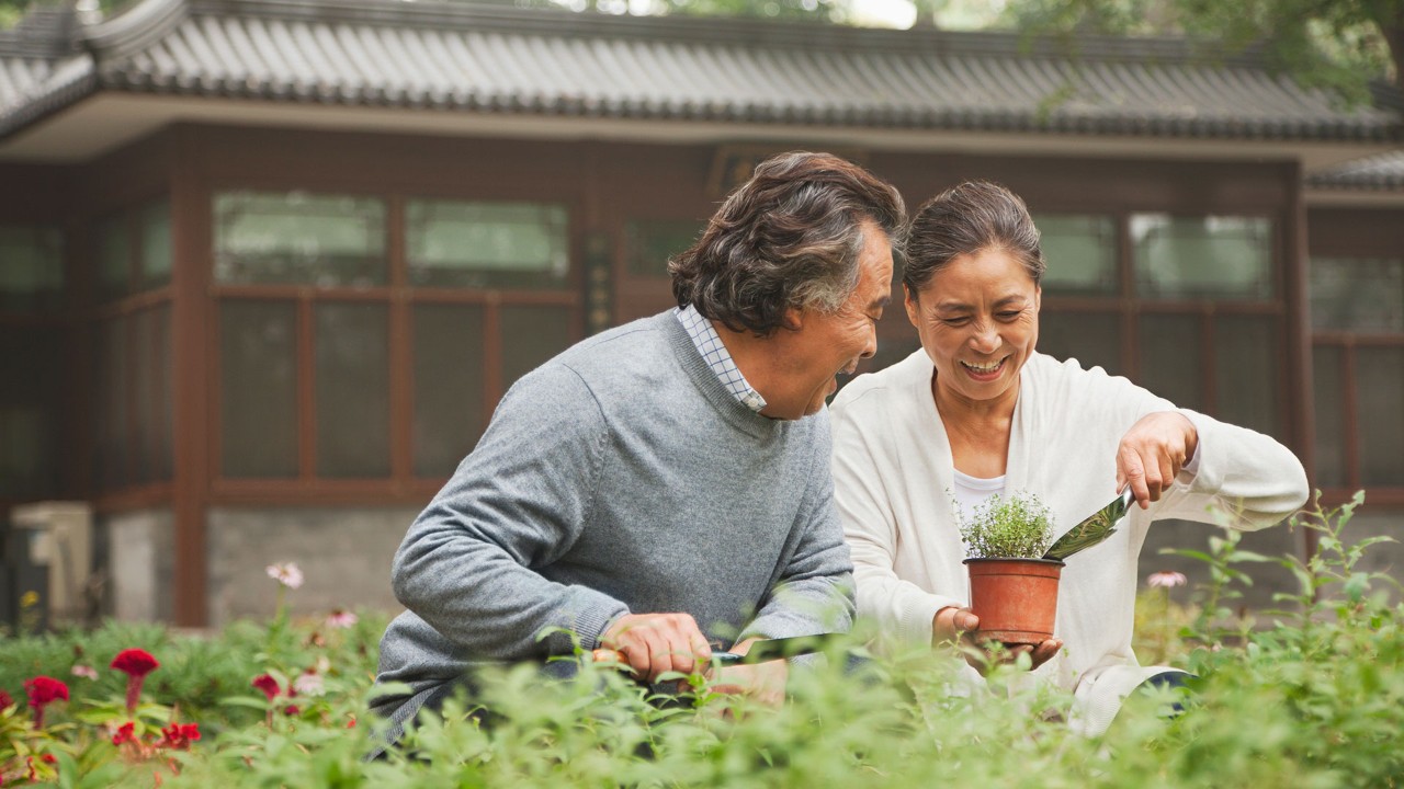 elderly couple look after plants; the image used for understanding legacy planning