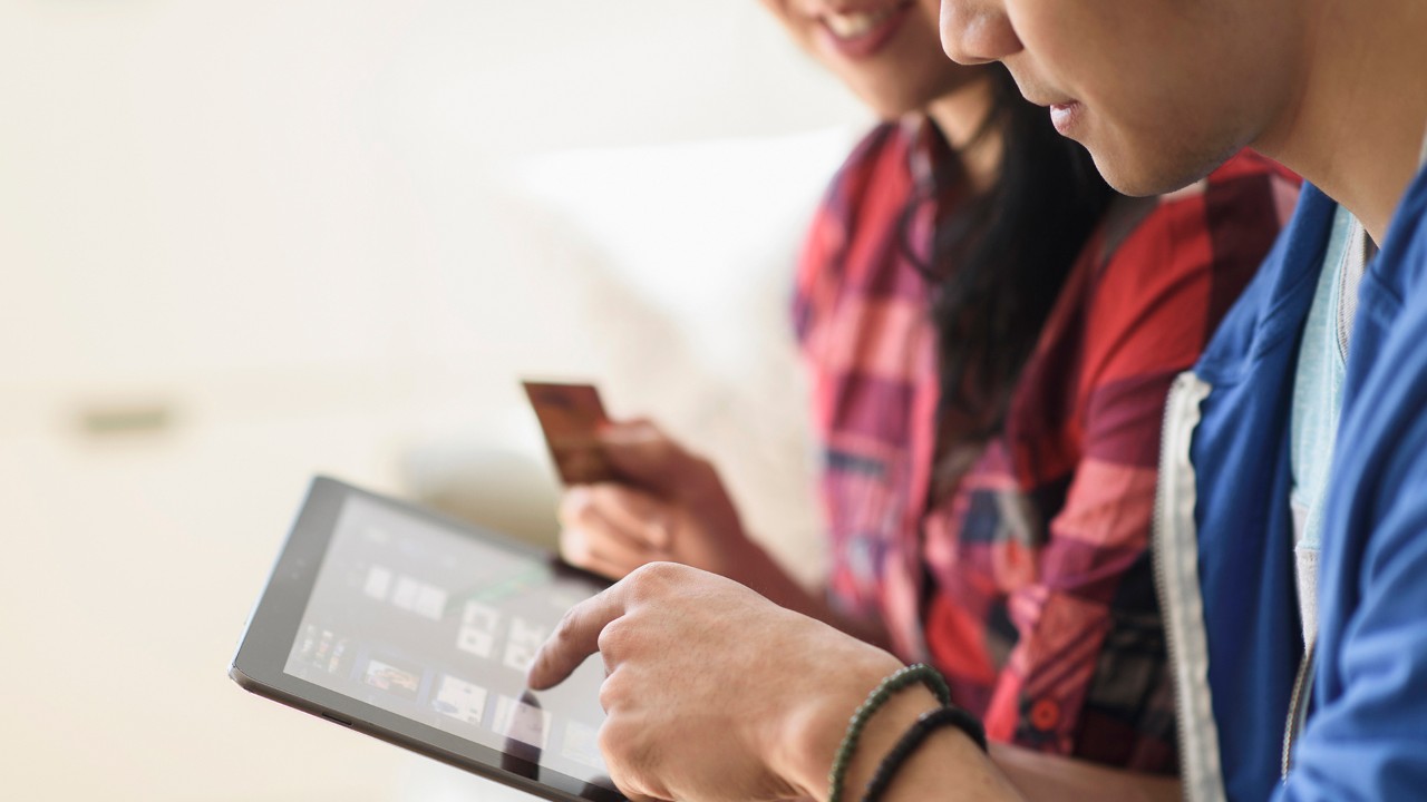 young people use tablet transfer; image used for Global transfer services