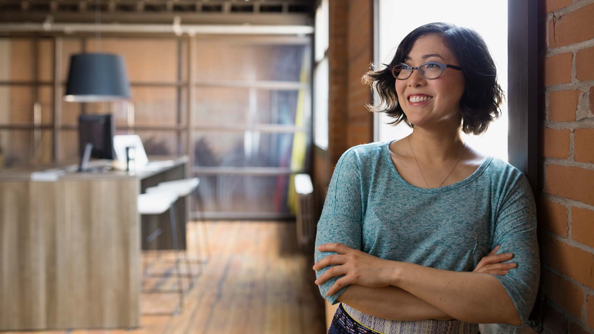 Lady leaning by the window; the image used for setting savings goals