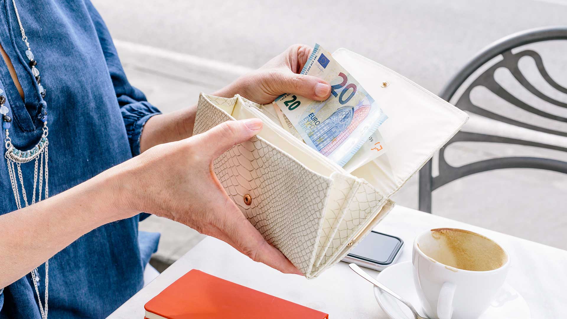 Woman viewing foreign currency in wallet