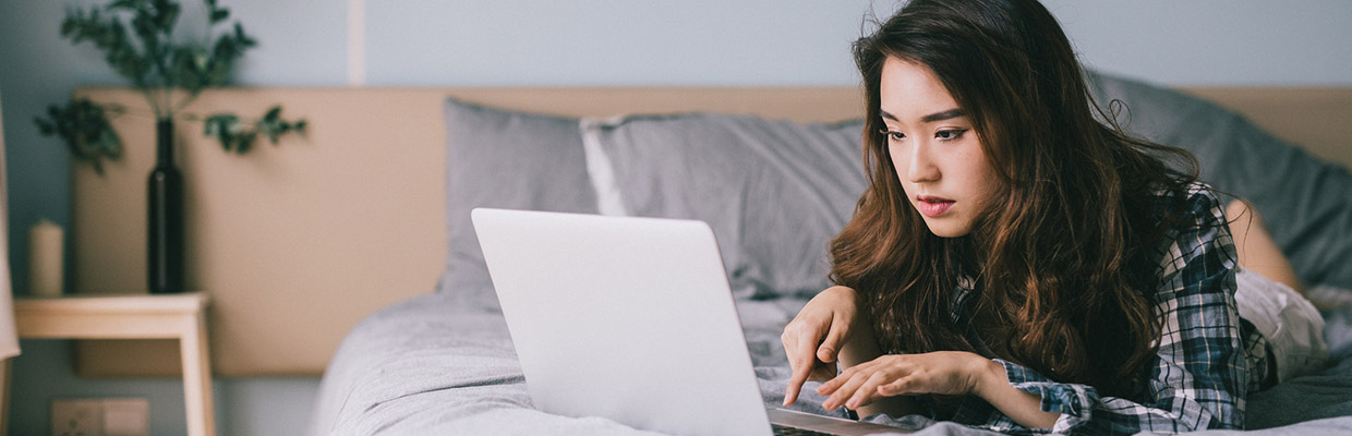 Girl watching computer in bed; the image used for understanding interest
